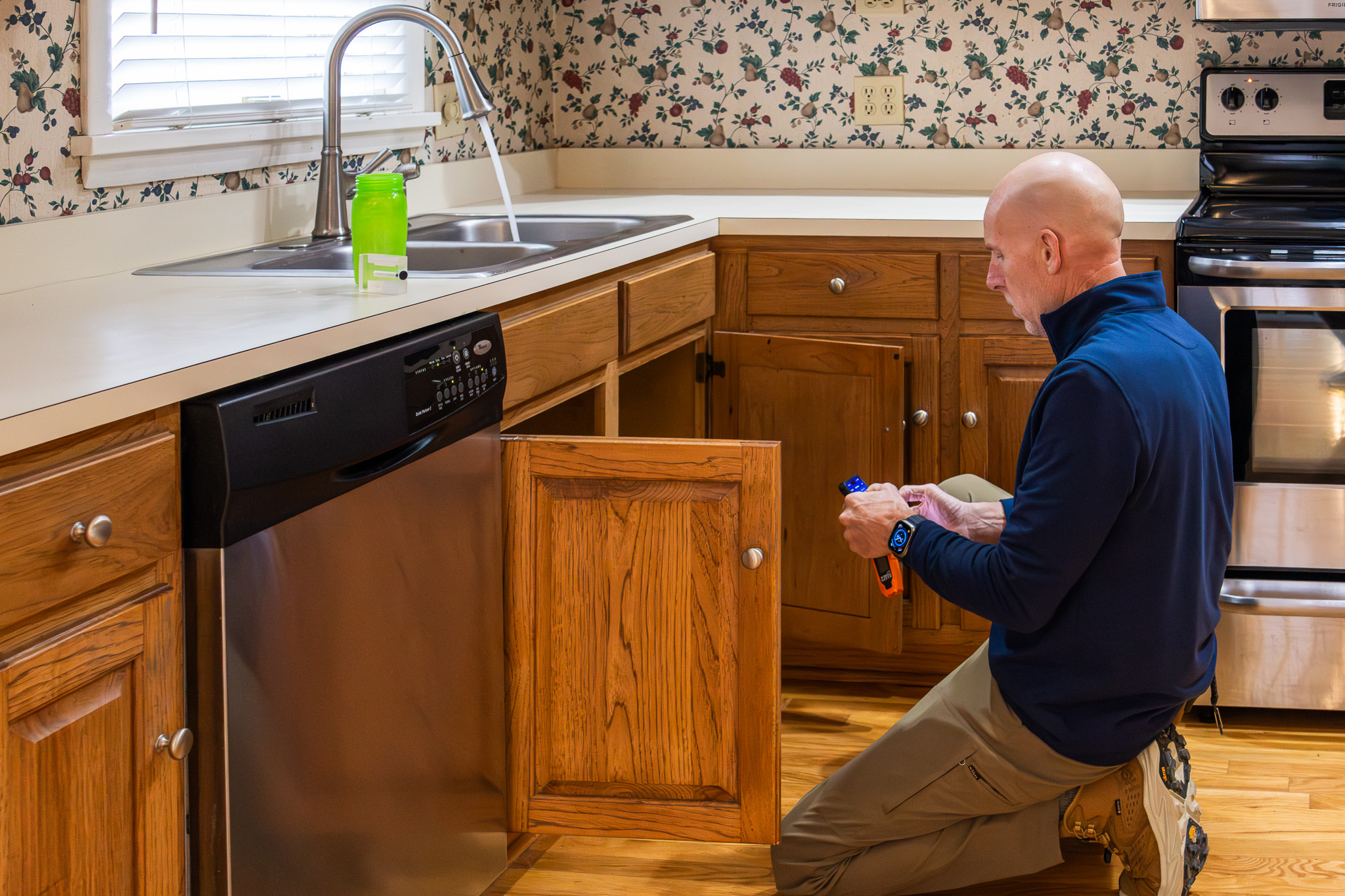 Mike Meurer standing in front of kitchen cabinets
